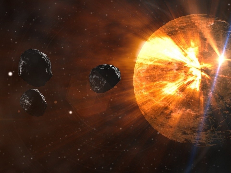 Imagen de asteroides acercándose a una estrella. 