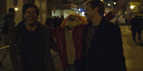 Capura de imagen de Nadie nos mira, tres hombres caminando uno de ellos con máscara de payaso