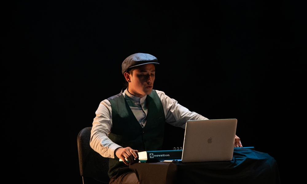 joven sentado frente a una pantalla de computador, una escena teatral joven sentado frente a una pantalla de computador, una escena teatral