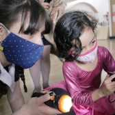Niña jugando con artista en laboratorio artístico