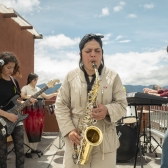 Un grupo de jóvenes toca instrumentos en una terraza