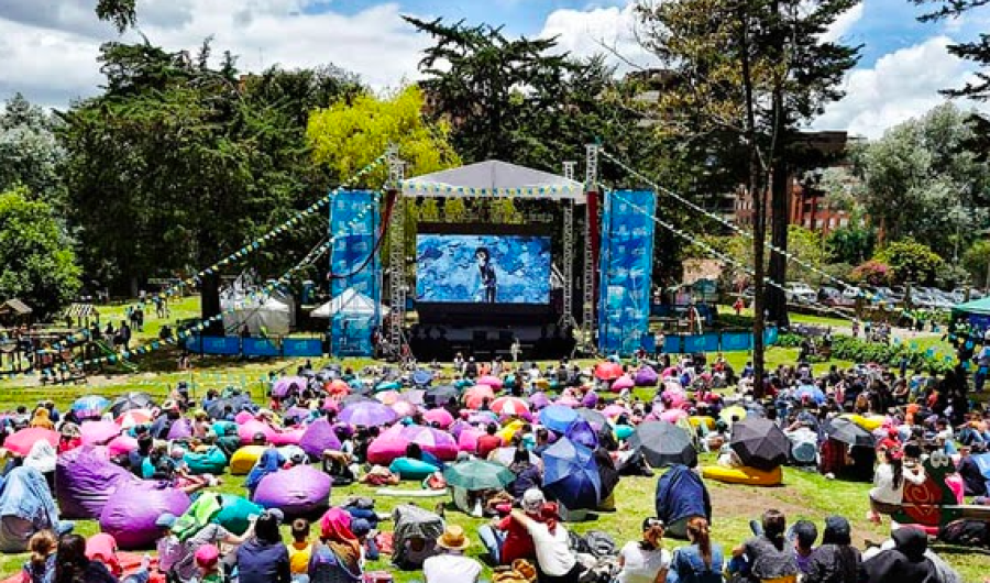 grupo de personas sentadas en el parque viendo películas