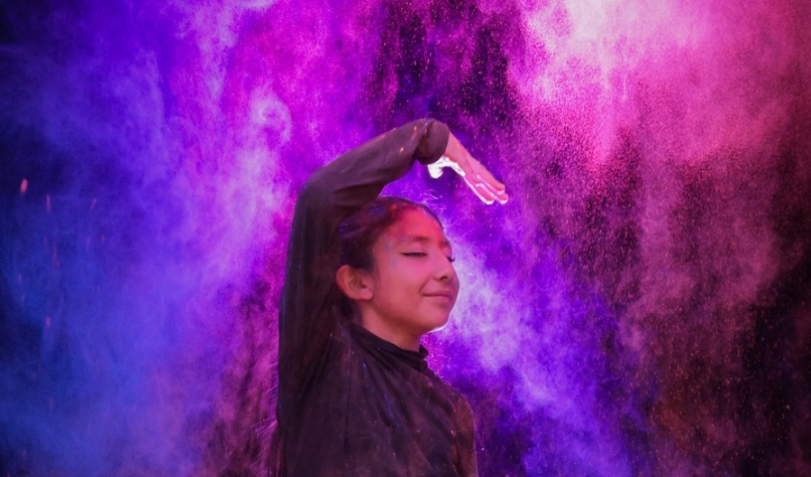 una niña danza en medio de luces de colores