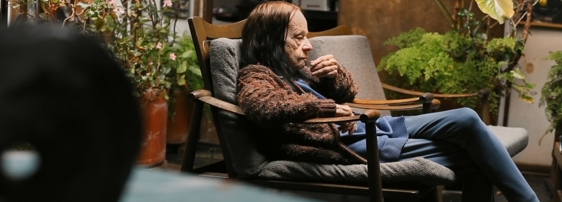 Mujer mayor sentada en una sala 